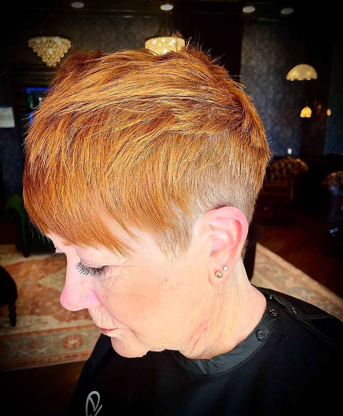 copper pixie hair with layers and bangs for women in their sixties