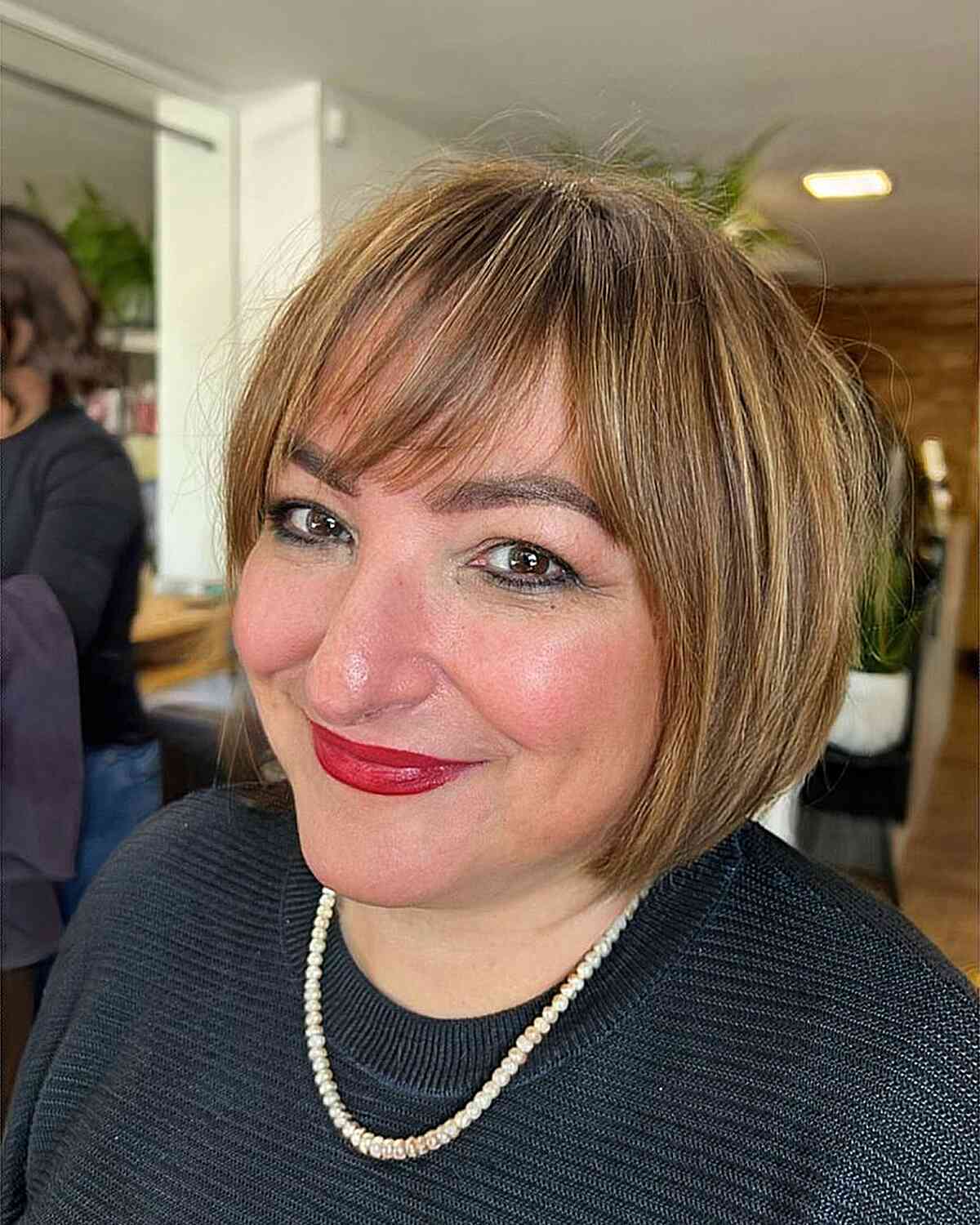 cropped bob with side swept bangs for round face shapes