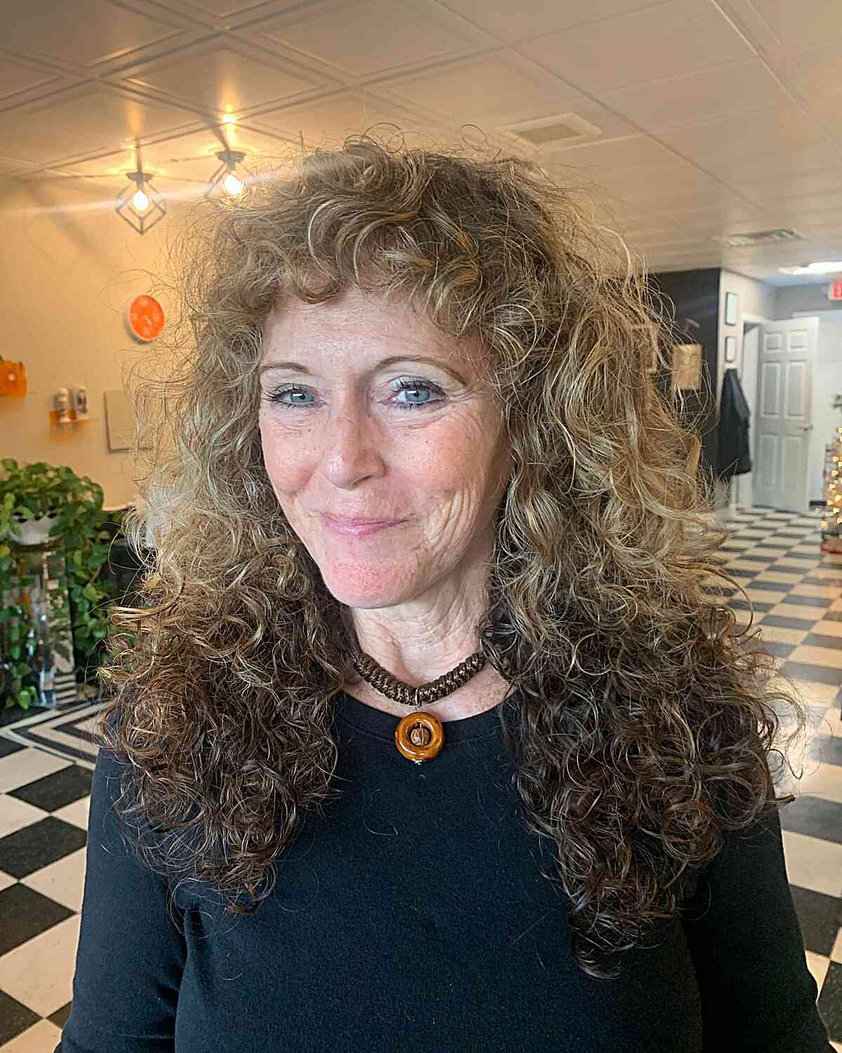 curly shag with log layers and short bangs on ladies in their 60s