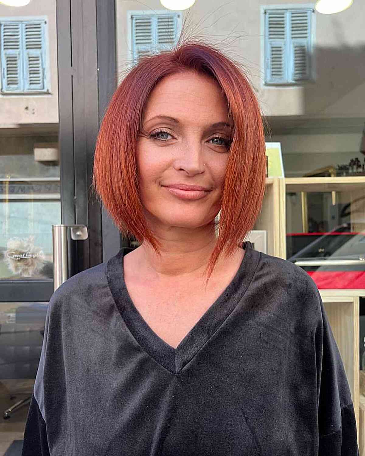 dark red a line bob cut with a side part
