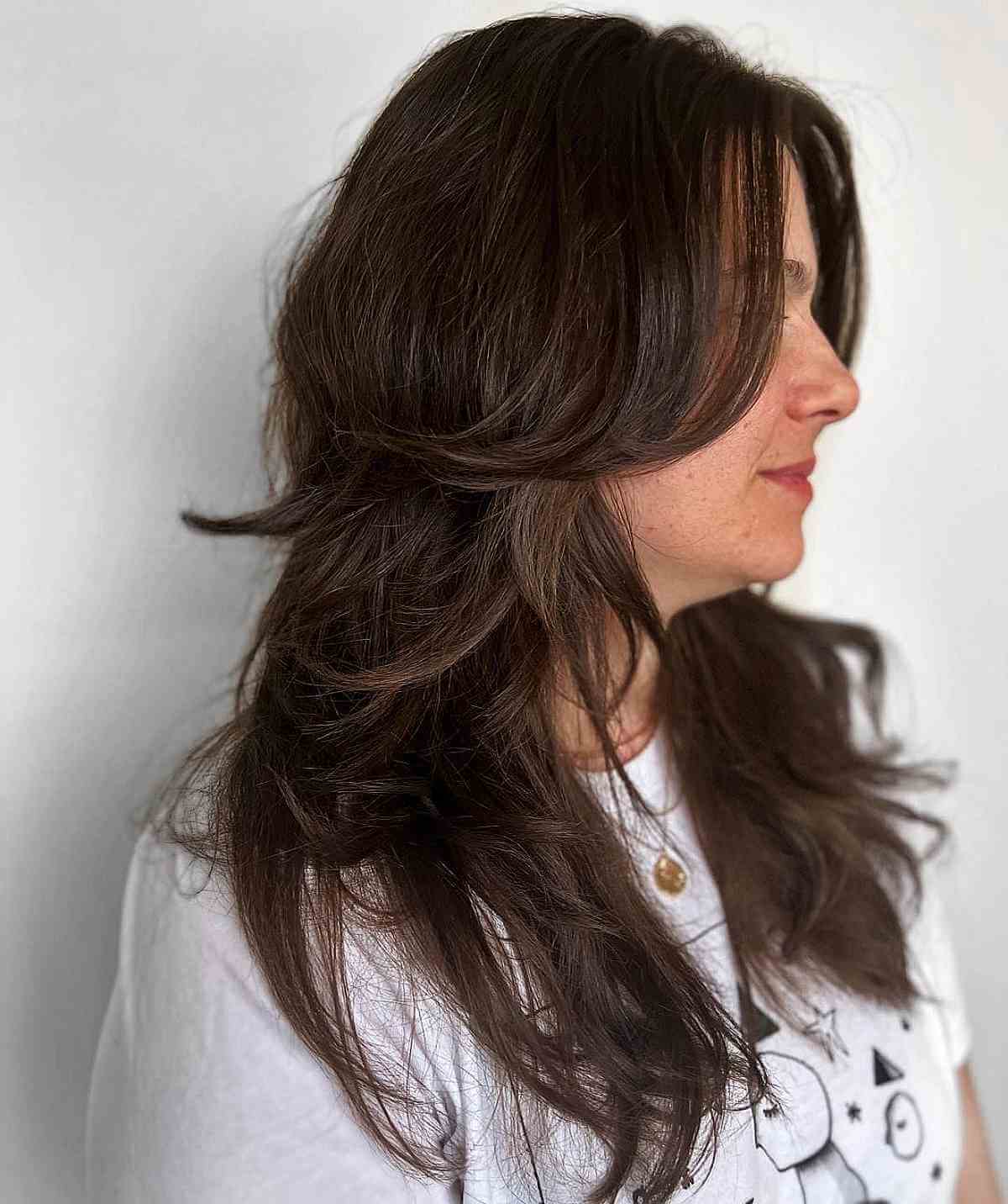 feathered layers on shagged hair on a woman in her 40s