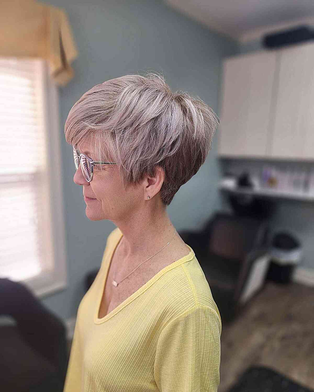 fluffy pixie bob with long side bangs for 60 year olds with eyeglasses