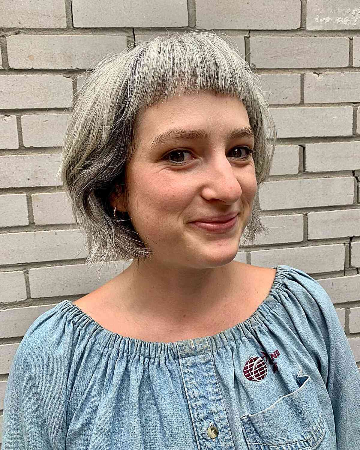 graduated chin length bob with micro bangs on fuller face shapes