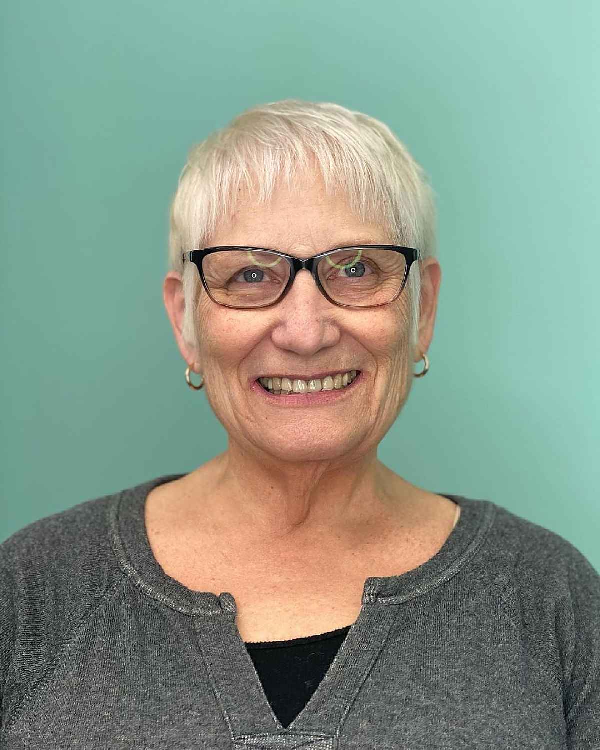icy blonde short haircut with wispy micro bangs for women over 60s