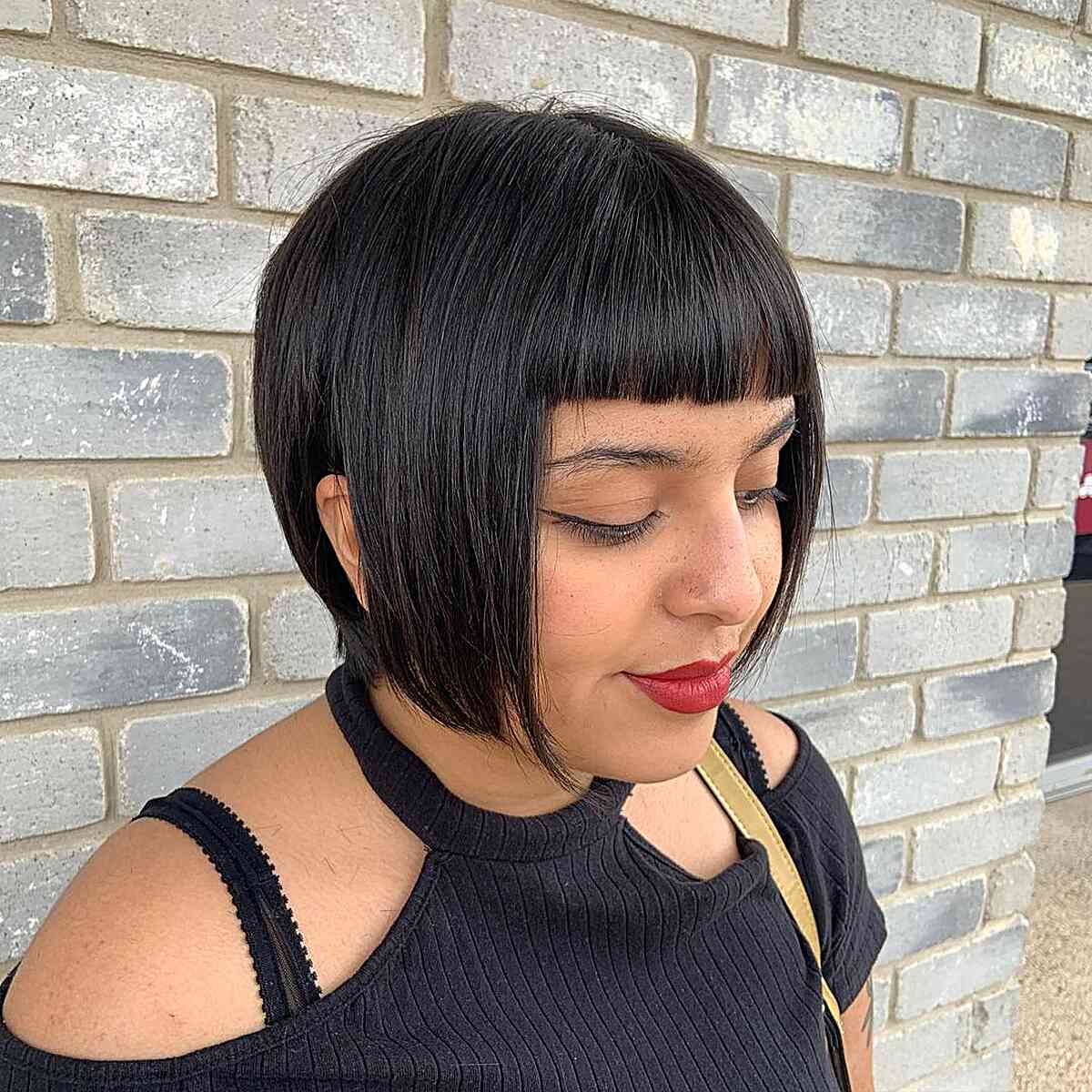 jaw length black pixie bob with mini fringe for round shaped faces