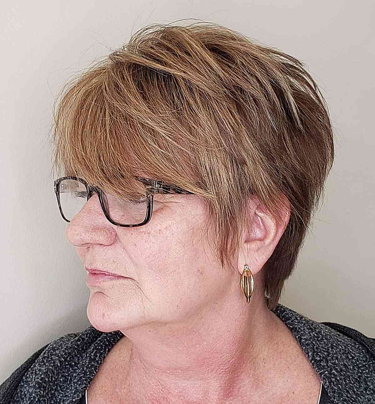layered long pixie and bangs on women over 60 with eyeglasses