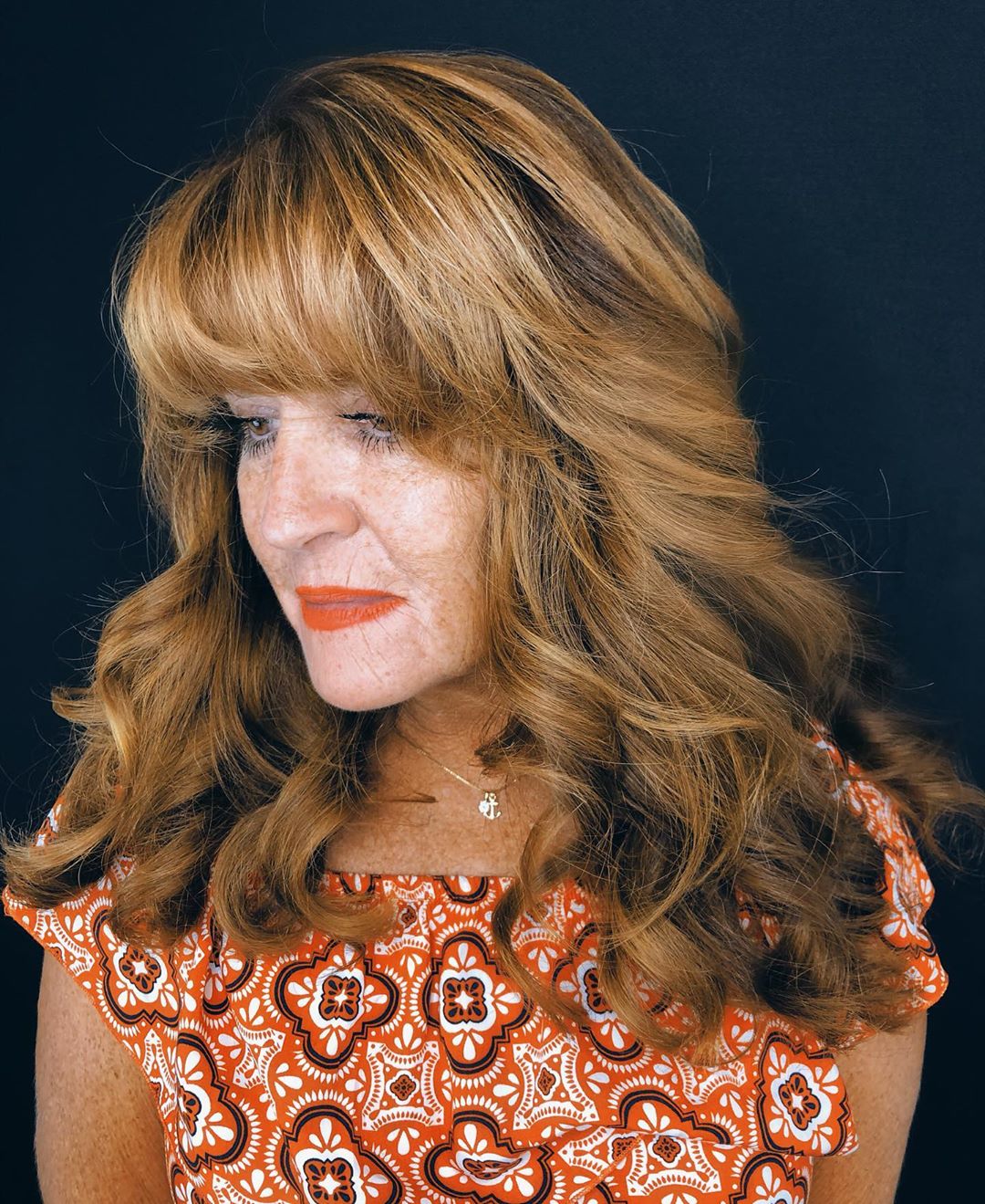 long hairstyle with blunt bangs for women over 50