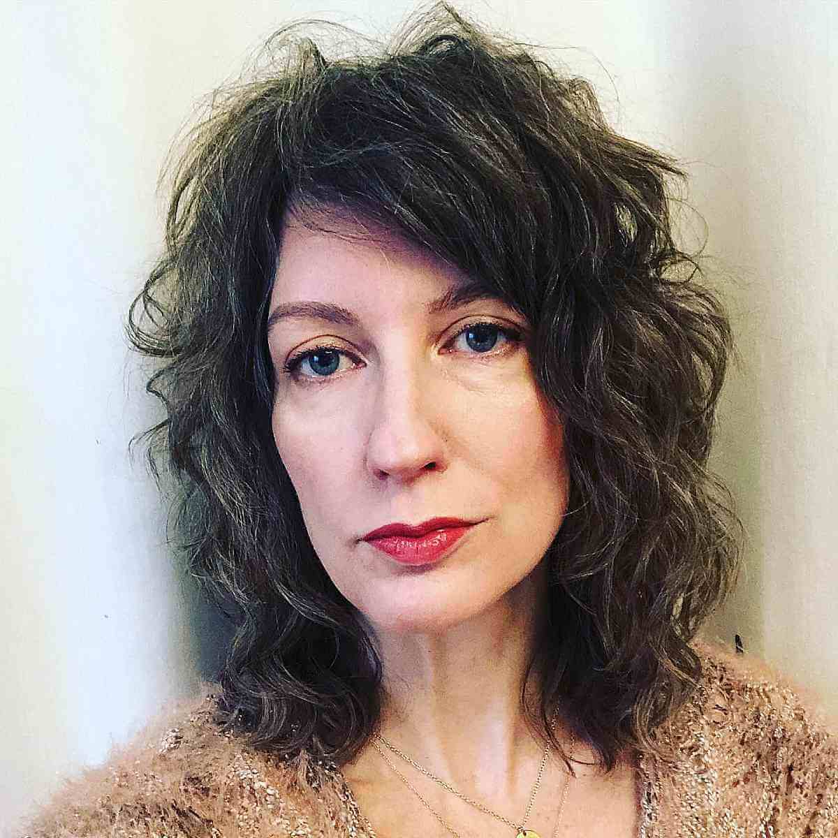 medium wavy shag with side bangs for women forty and over