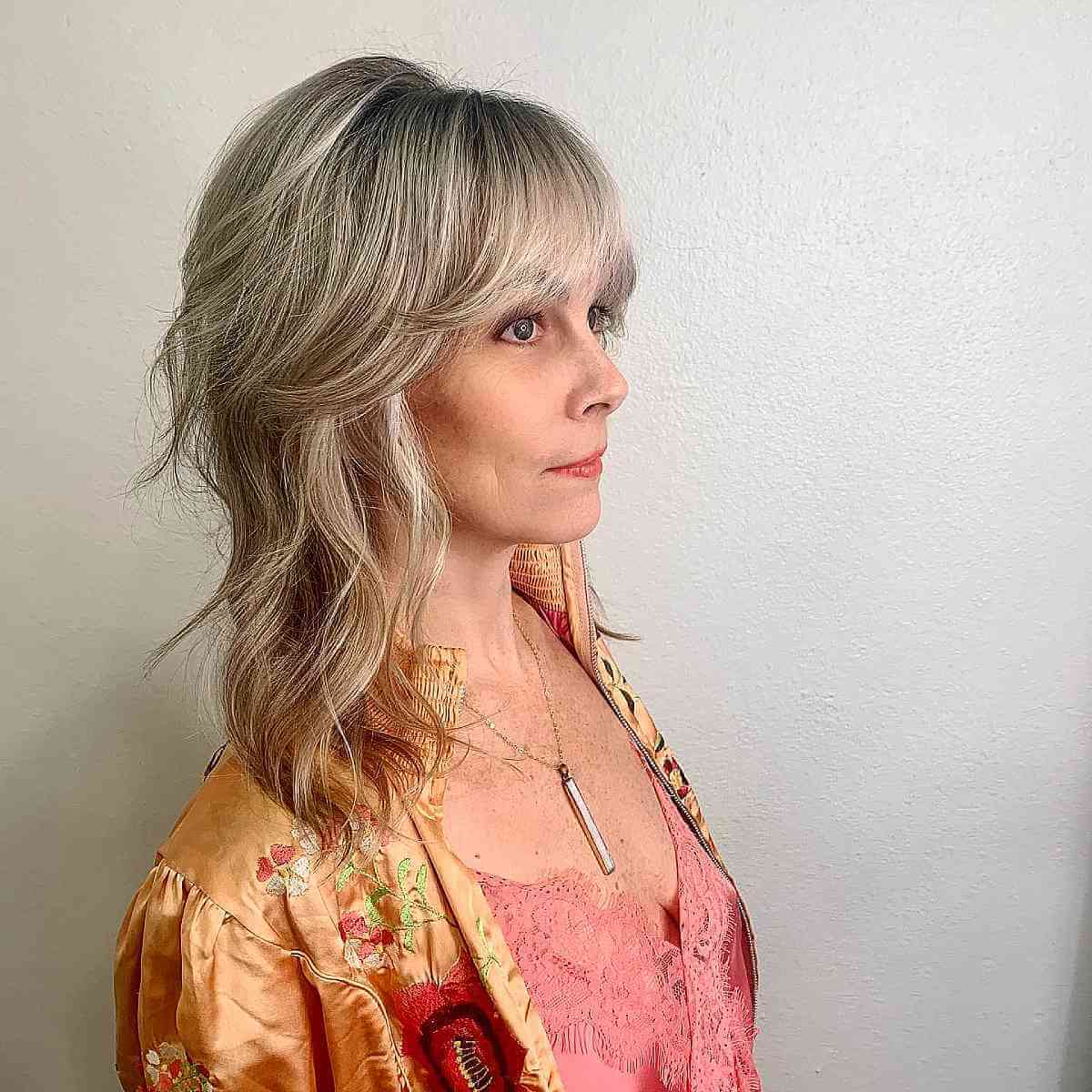 mid length shaggy layers with wispy bangs for women over 40