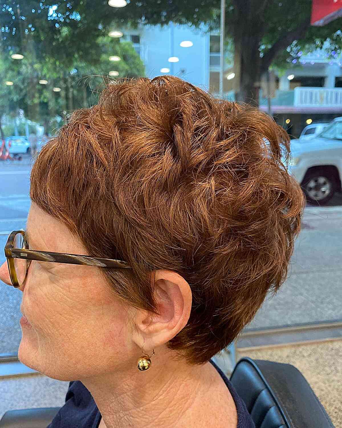 modern layered pixie crop with micro bangs for women aged 60 with eyeglasses