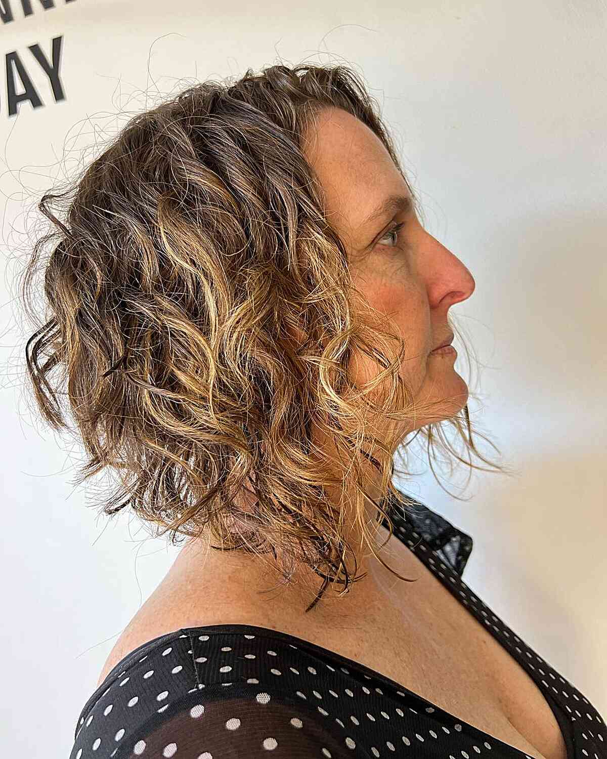 short a line cut with curly and choppy layers for mature women aged 60