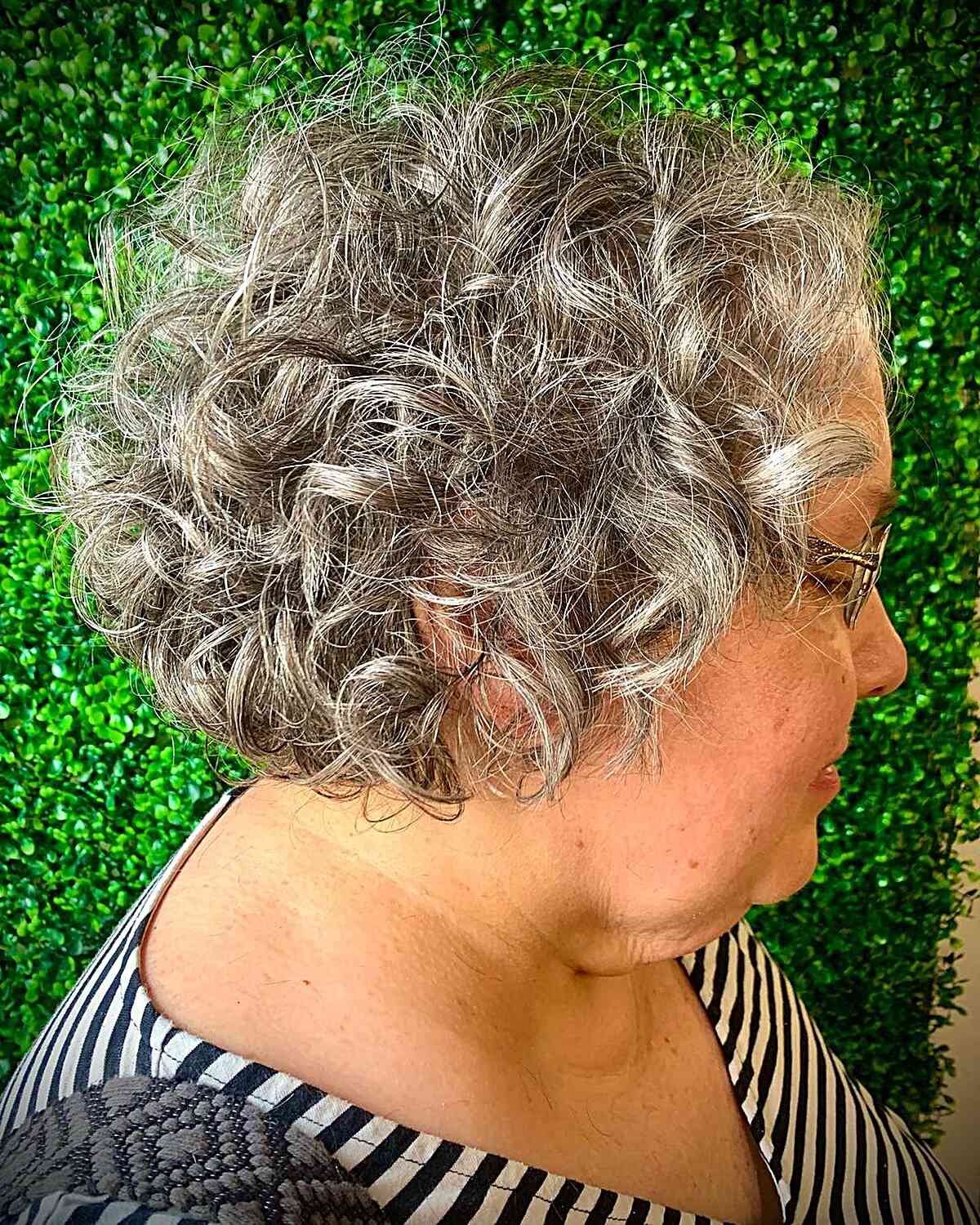 short and tousled mini bob with curls for women over 60 years old