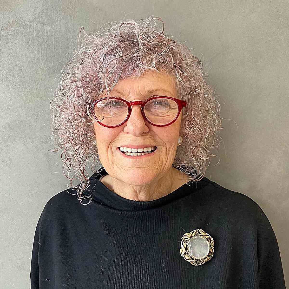 short asymmetrical platinum curls for older women over 60