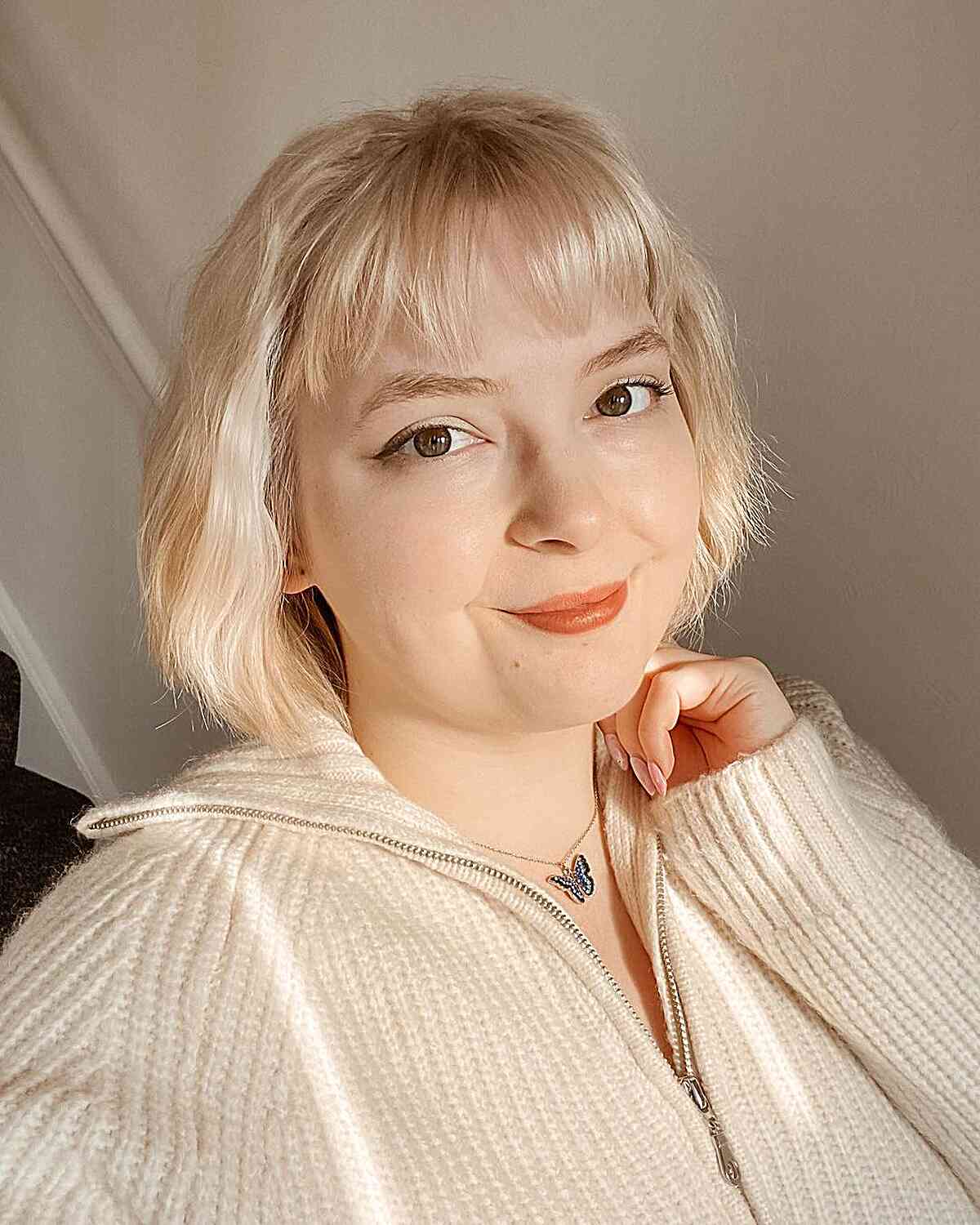 short classic choppy bob with light bangs for round shaped faces