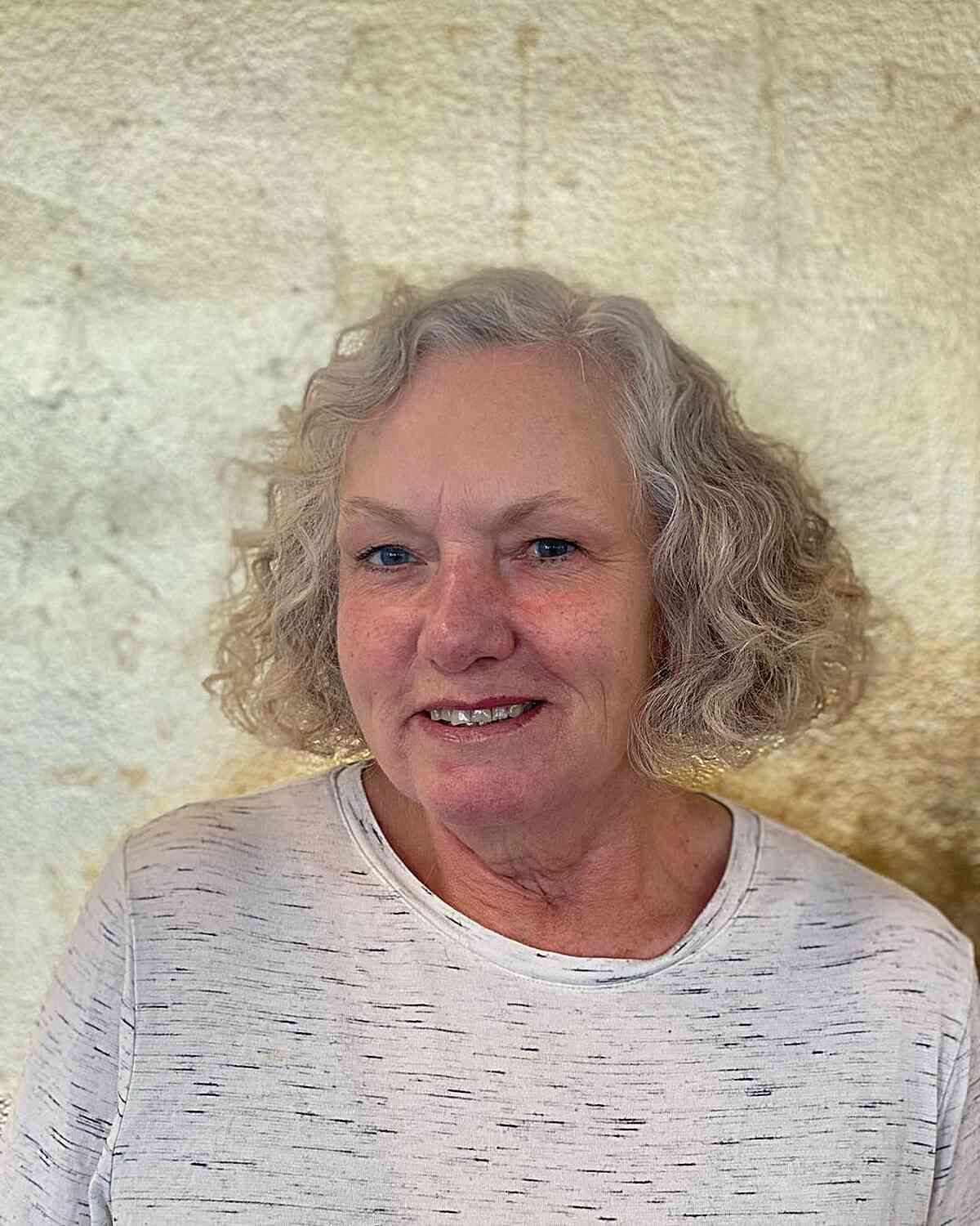 short length triangle bob with loose curls for women in their 60s
