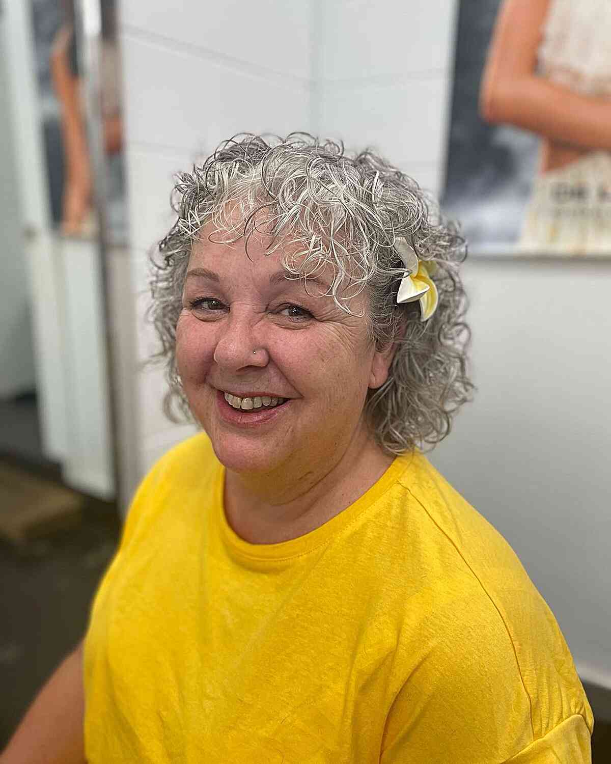 short messy curls with wispy front bangs on gorgeous women aged 60