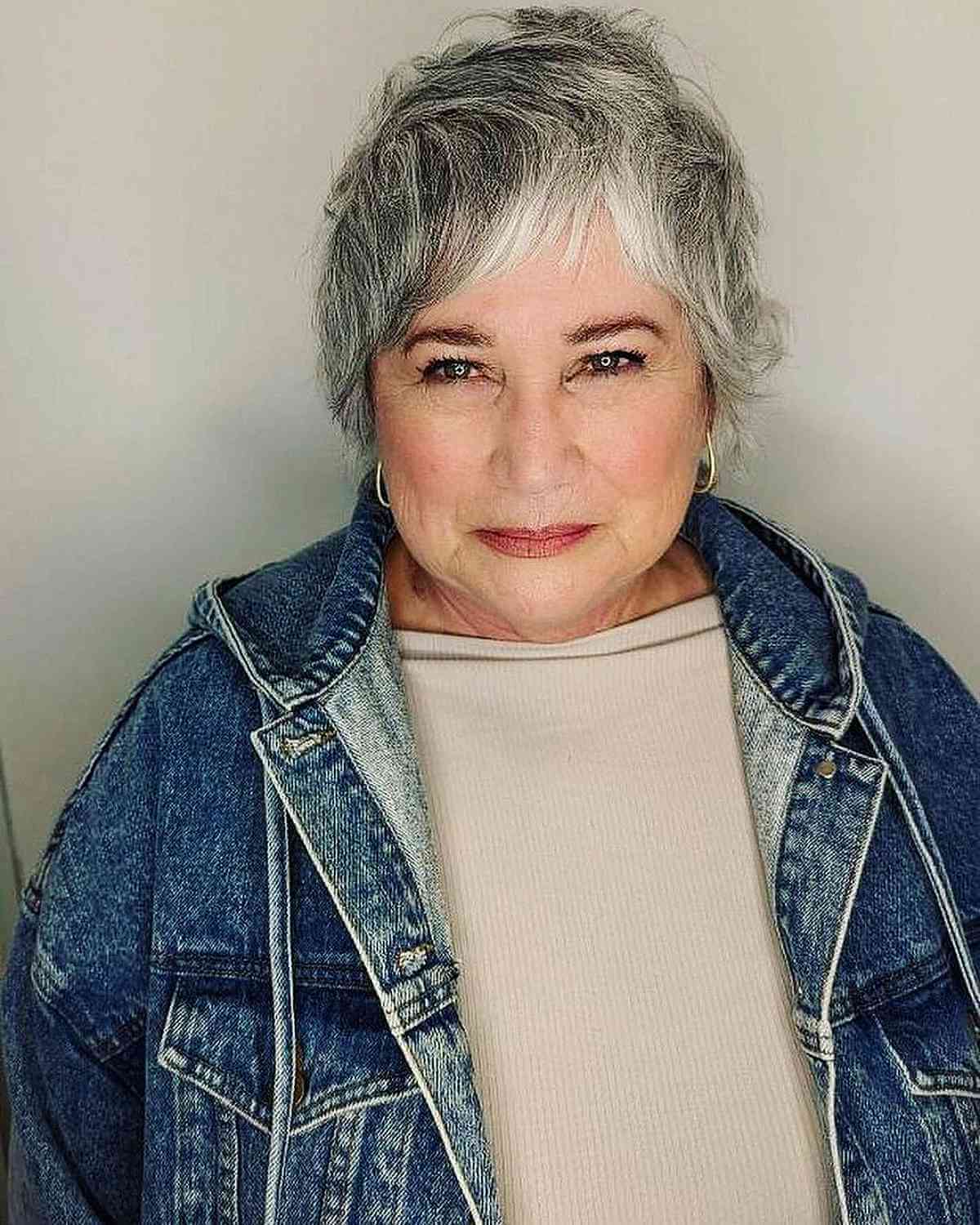 short pixie shag with asymmetrical bangs for older women