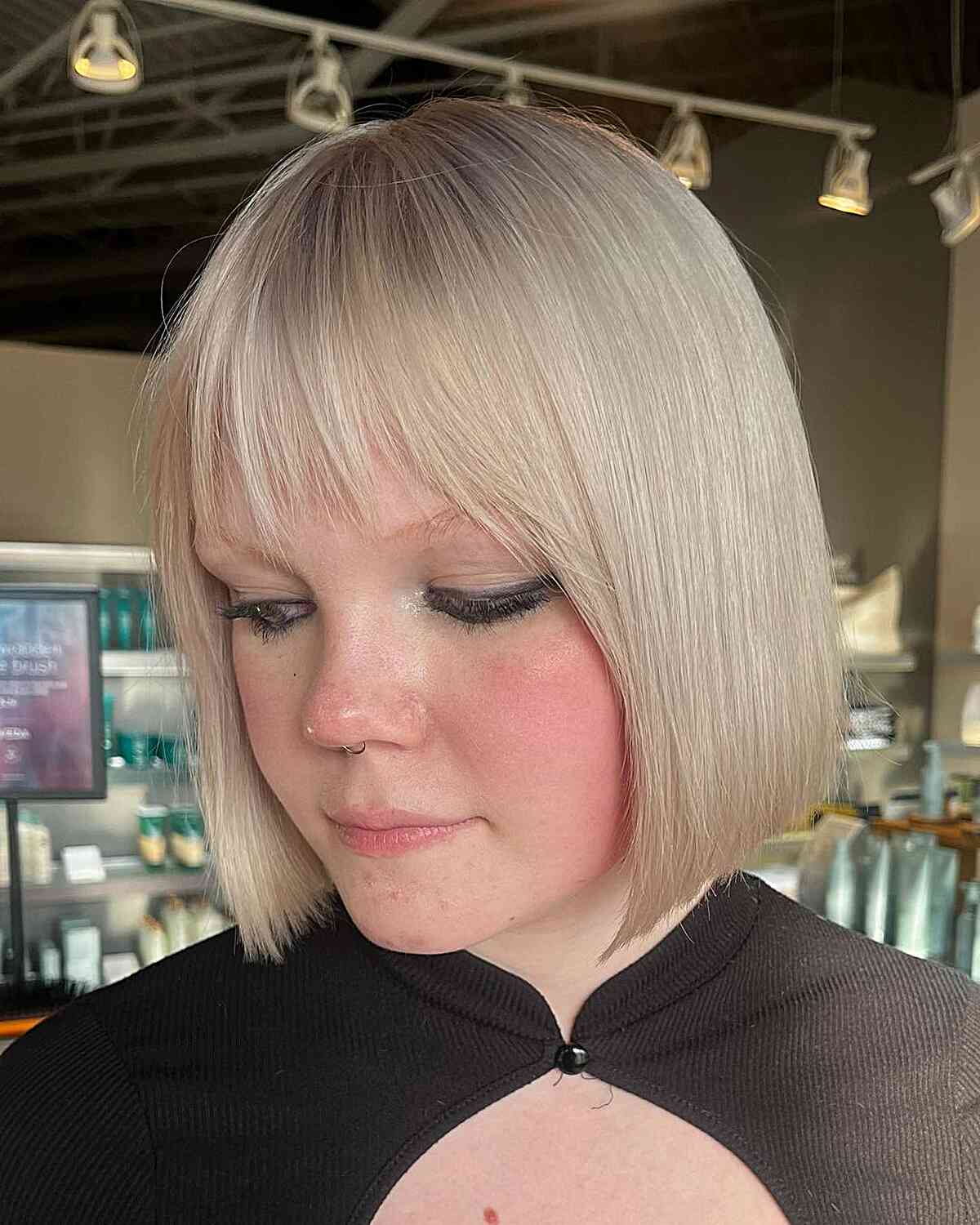 short white blonde blunt bob with choppy bangs for round faced women