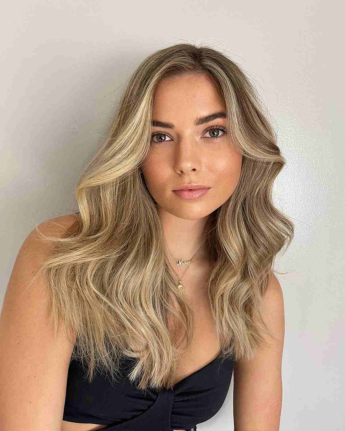 simple tousled blonde hair with a shadow root