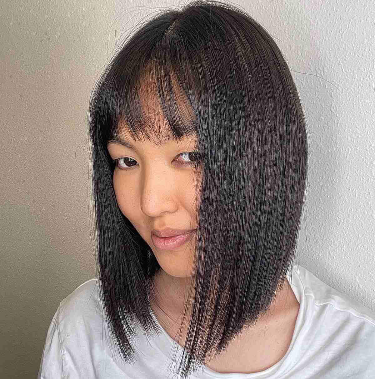 sleek collarbone bob with thin bangs for thinning hair