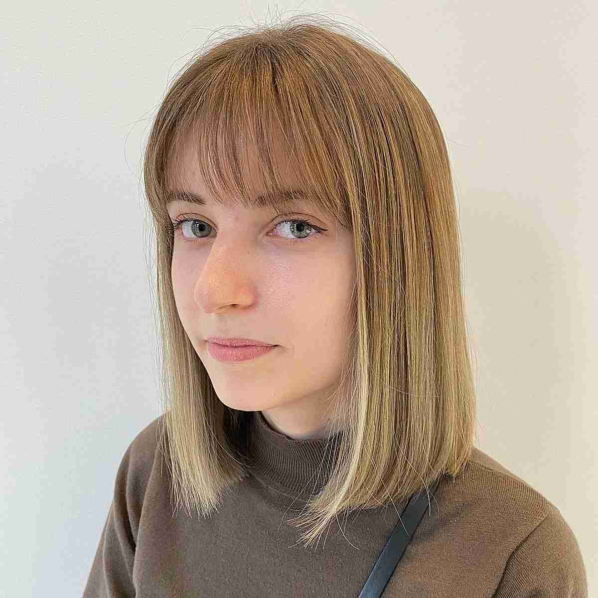 straight shoulder length sliced bob with wispy bangs
