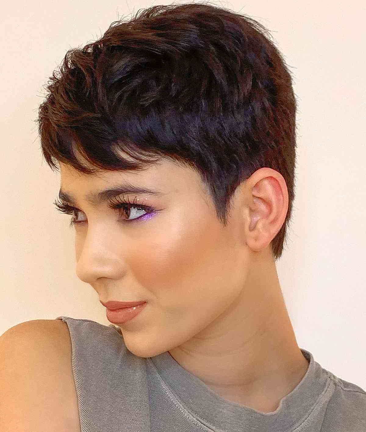 androgynous and feminine dark brown pixie with side swept bangs