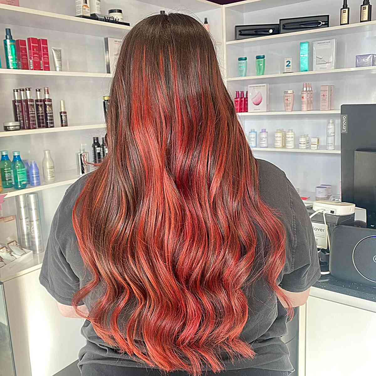 balayage hair with vivid strawberry red and brown roots