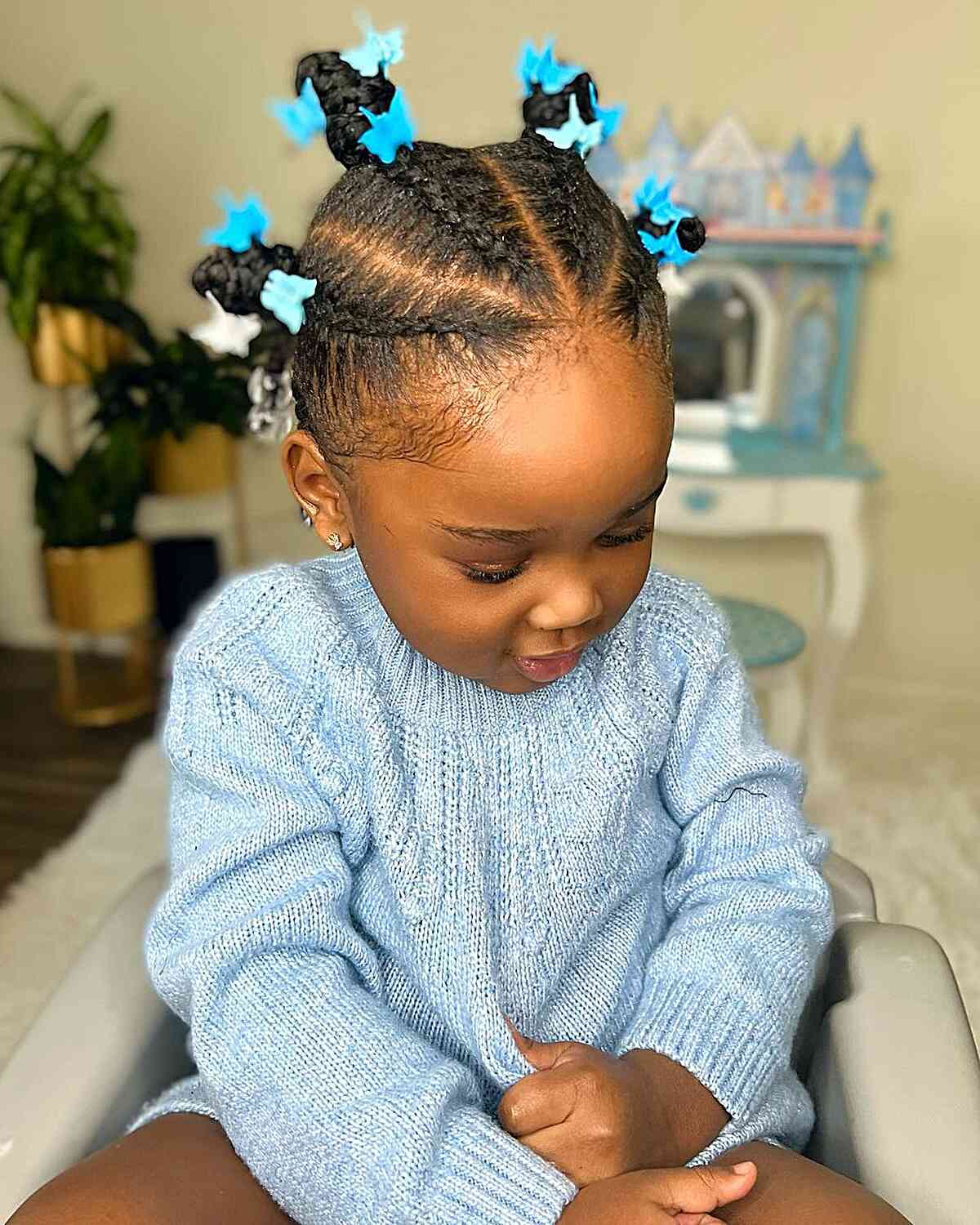 cornwos and mini buns with butterfly clips for young black toddler girls