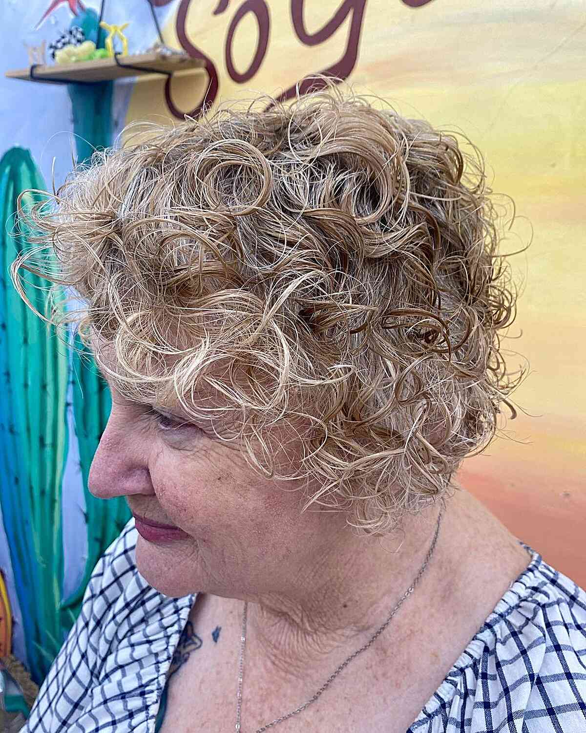 curly short jaw length hair with dimensional blonde color for 60 year olds