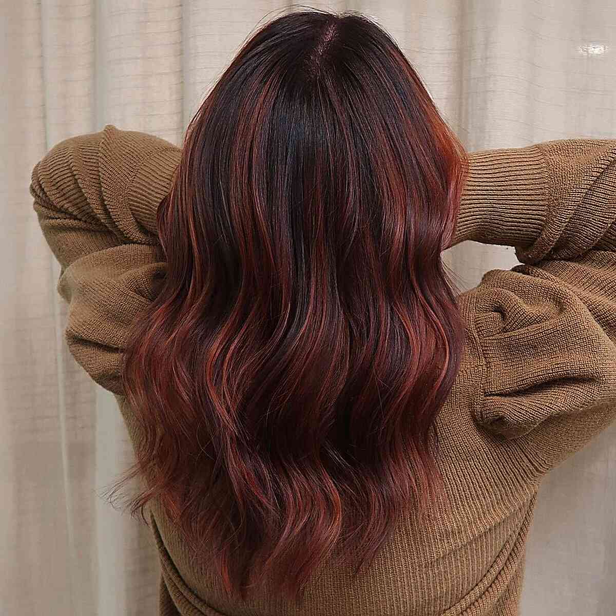 dark brown hair with light auburn red balayage highlights