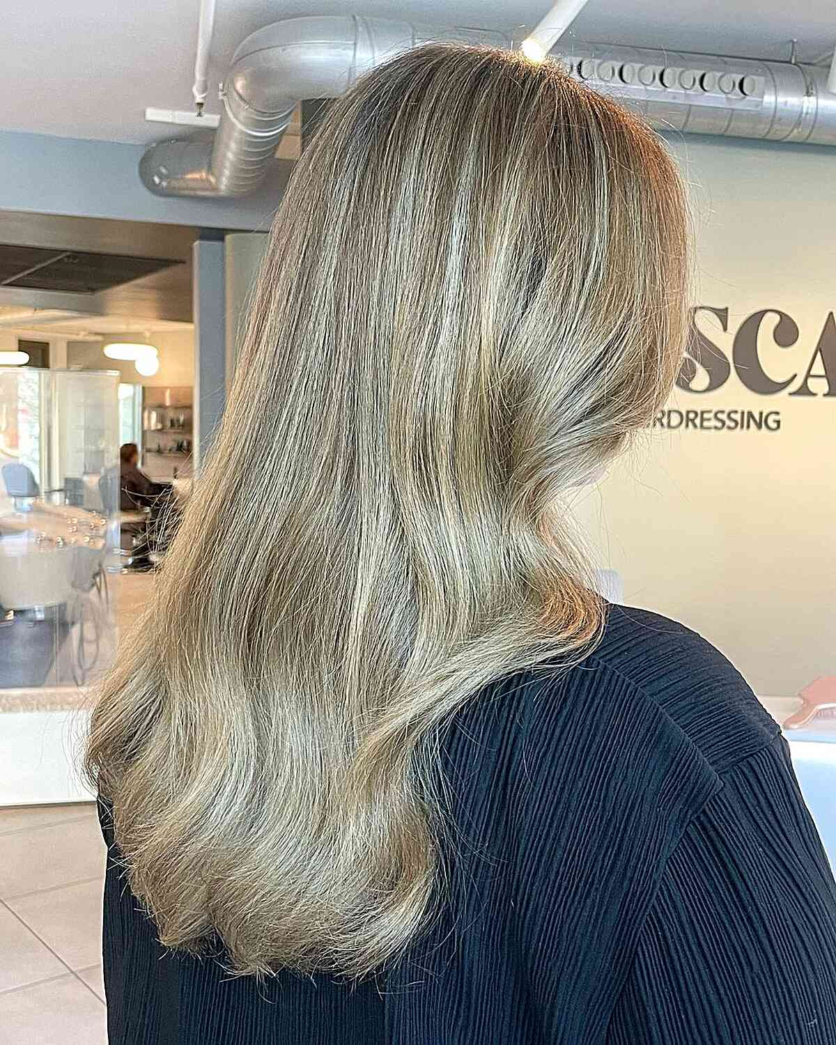 dirty beachy blonde balayage with soft honey hues