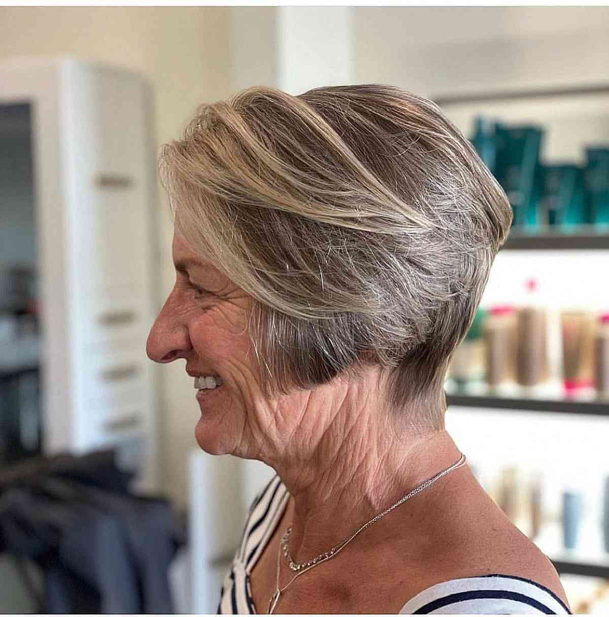 ear length stacked haircut for ladies over 70s with long bangs