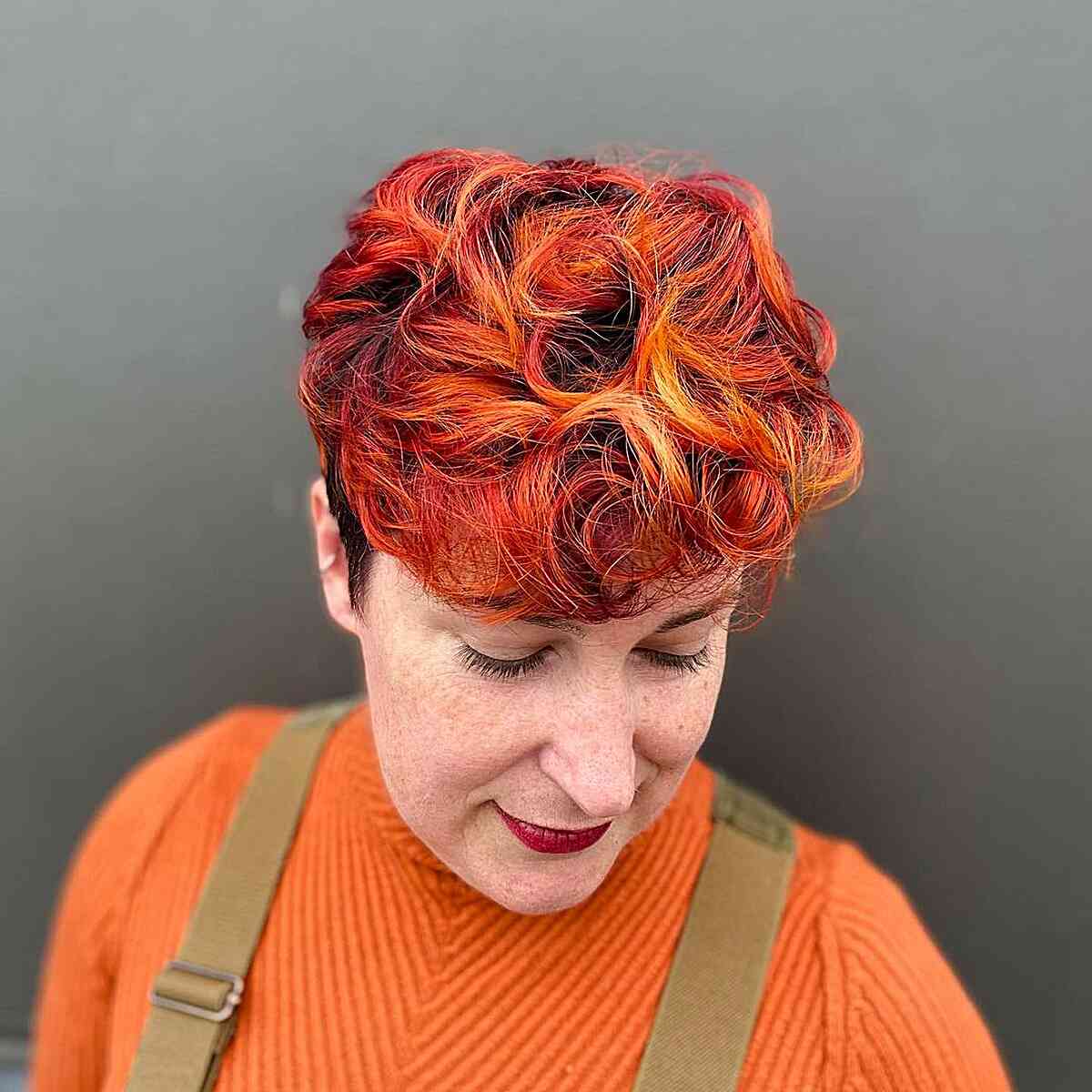 fire copper short hair with textured layers and curls for older ladies