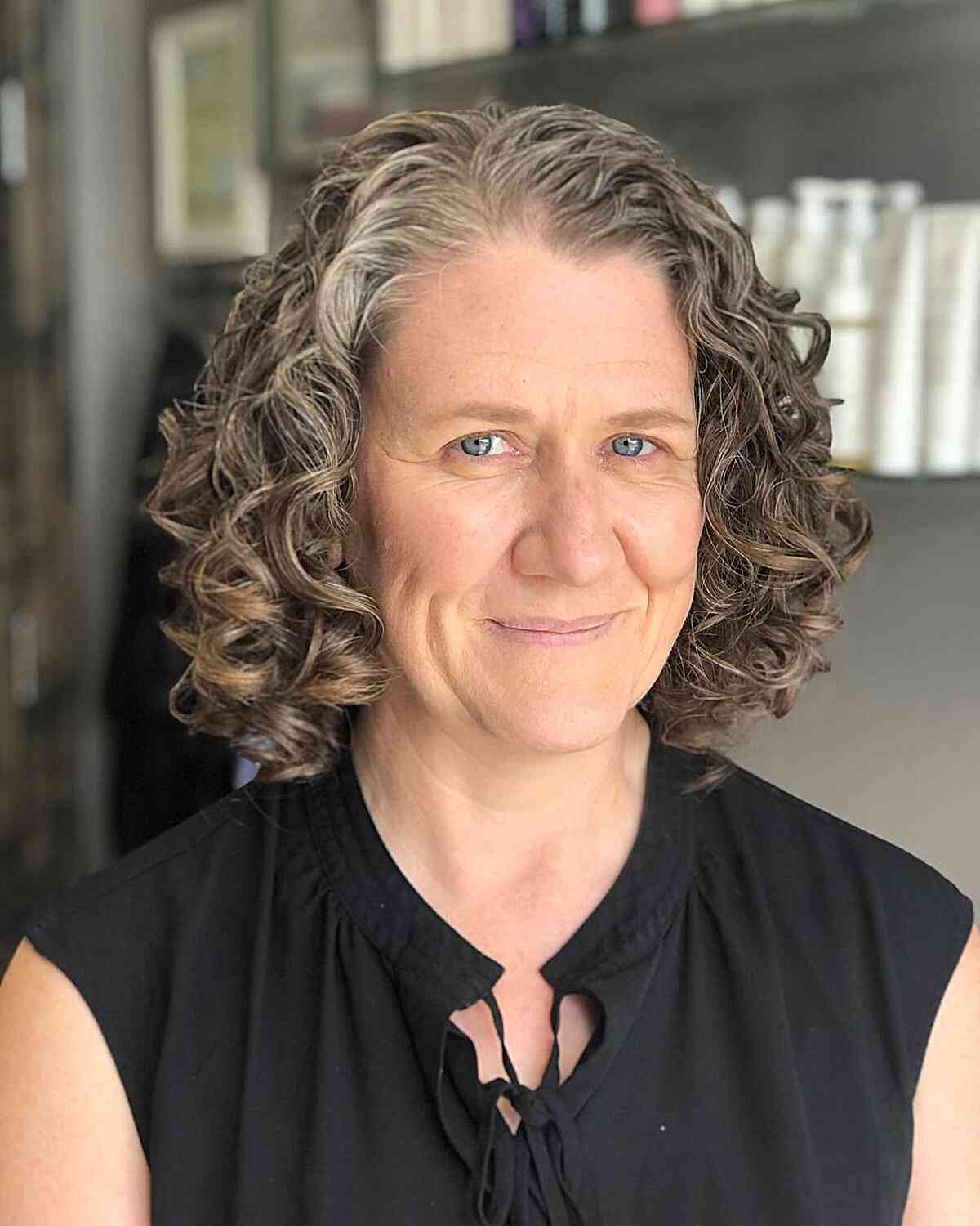 gray chin length bob with curls on older women