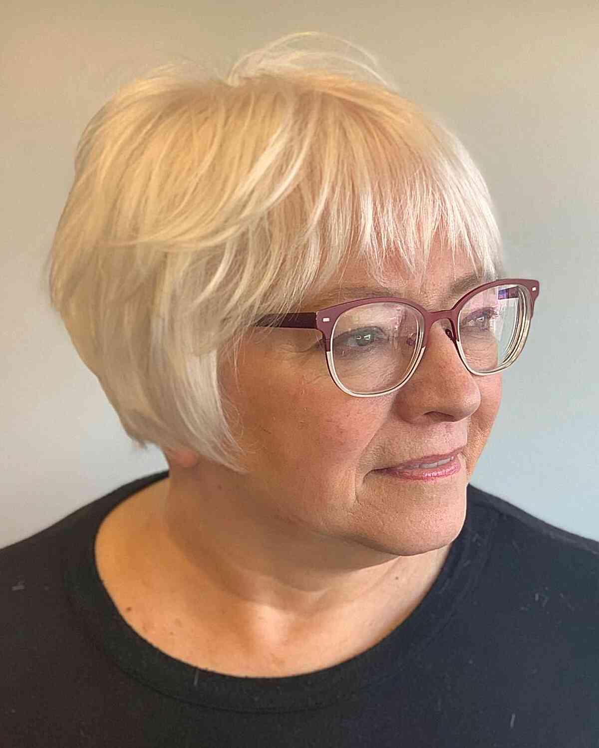 jaw grazing white french bob with choppy bangs for women aged 60