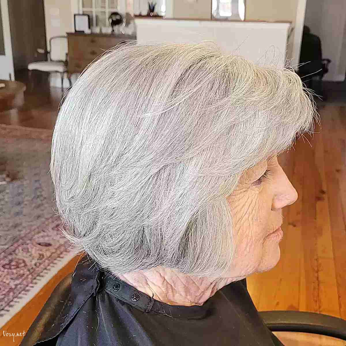 jaw length feathery layered bob with side swept bangs for women over 60