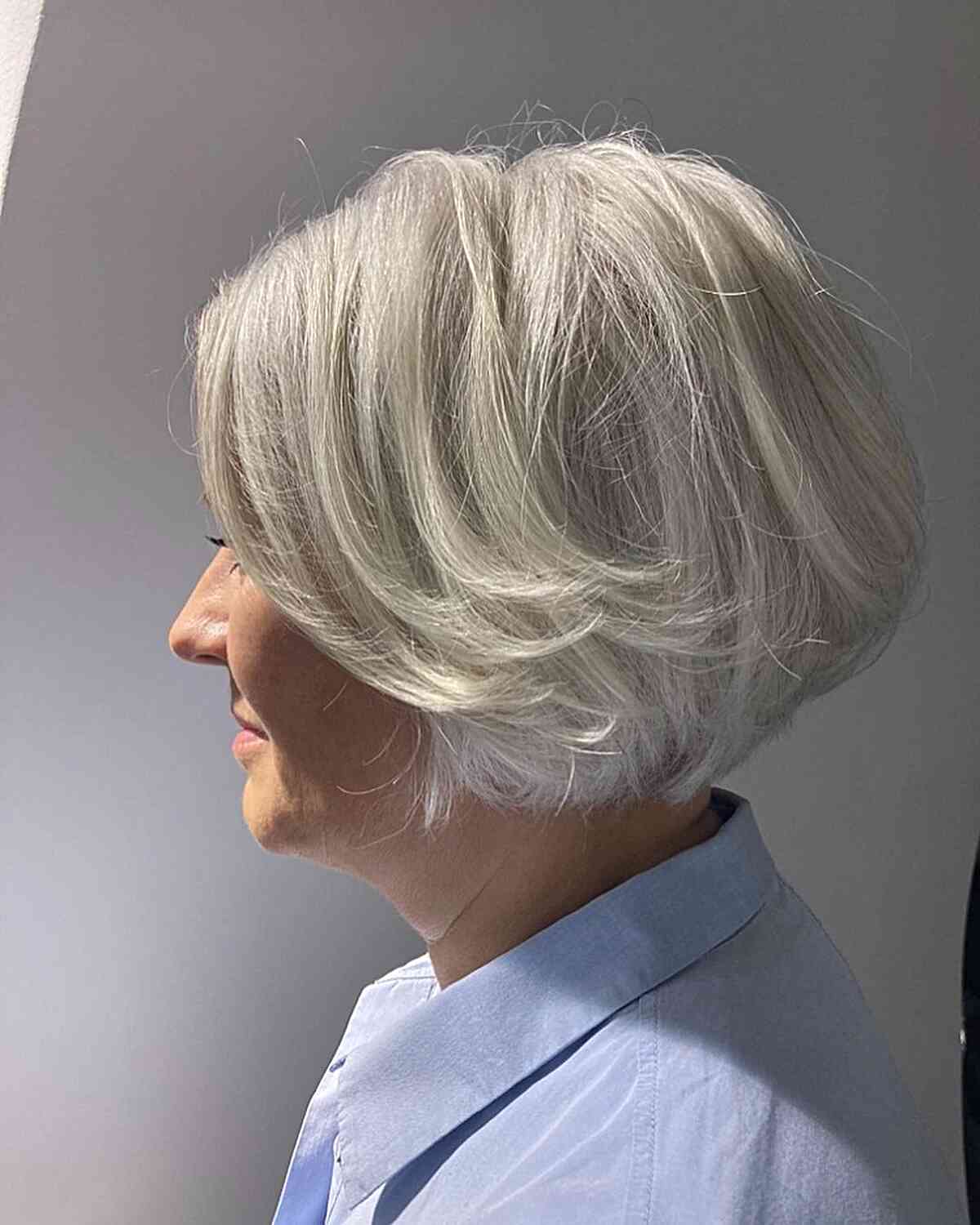 jaw length fluffy white bob with feathered layers on older ladies over 60