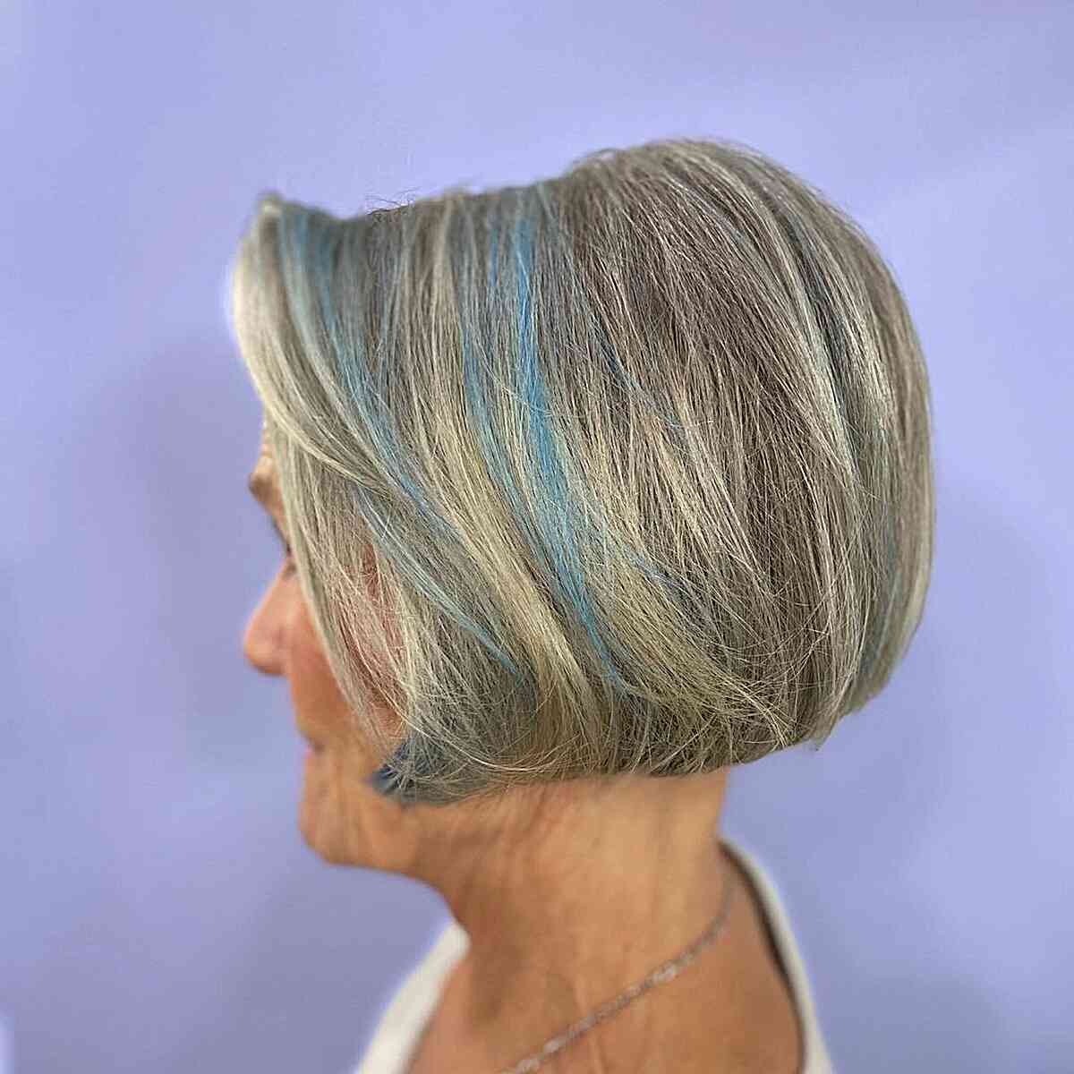 jaw length salt and pepper bob with blue accents for modern ladies aged 60