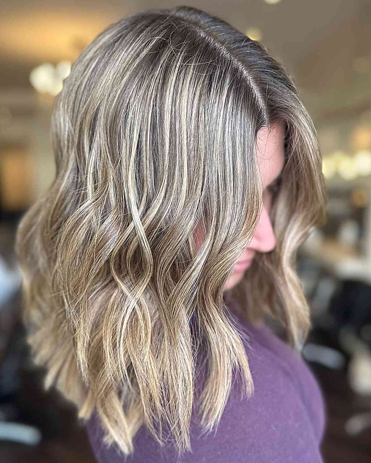 medium layered cut with dirty lived in blonde balayage hue