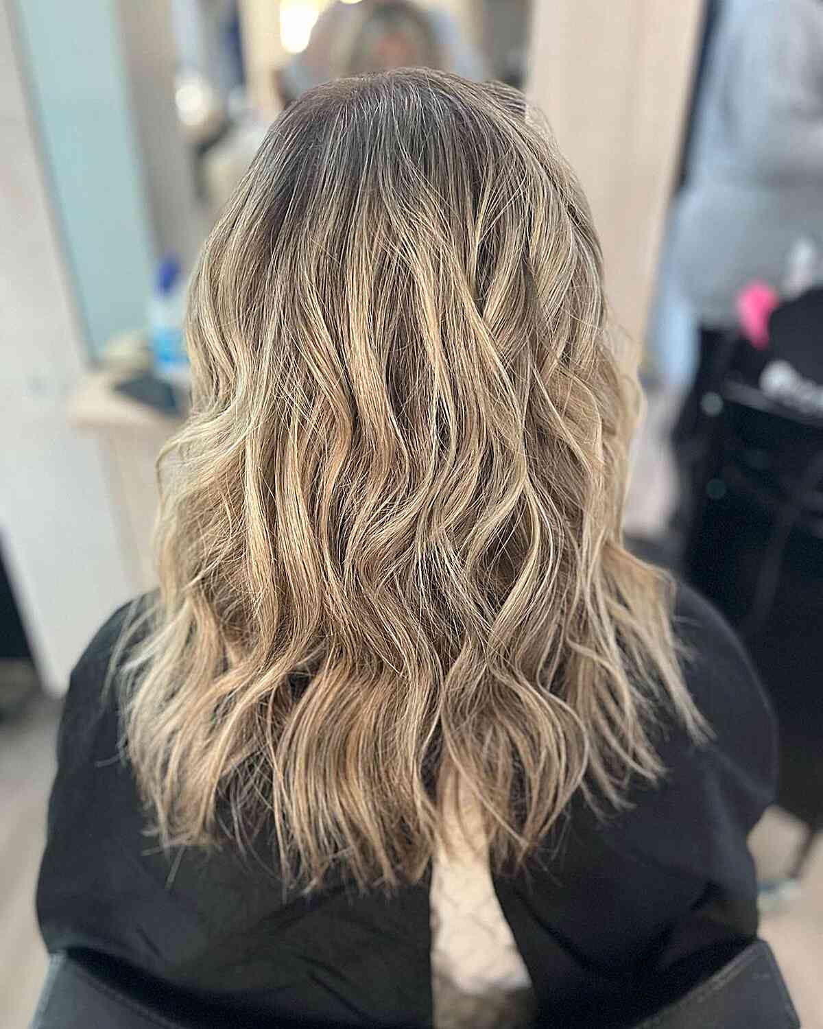 mid length messy waves on dirty neutral blonde balayage