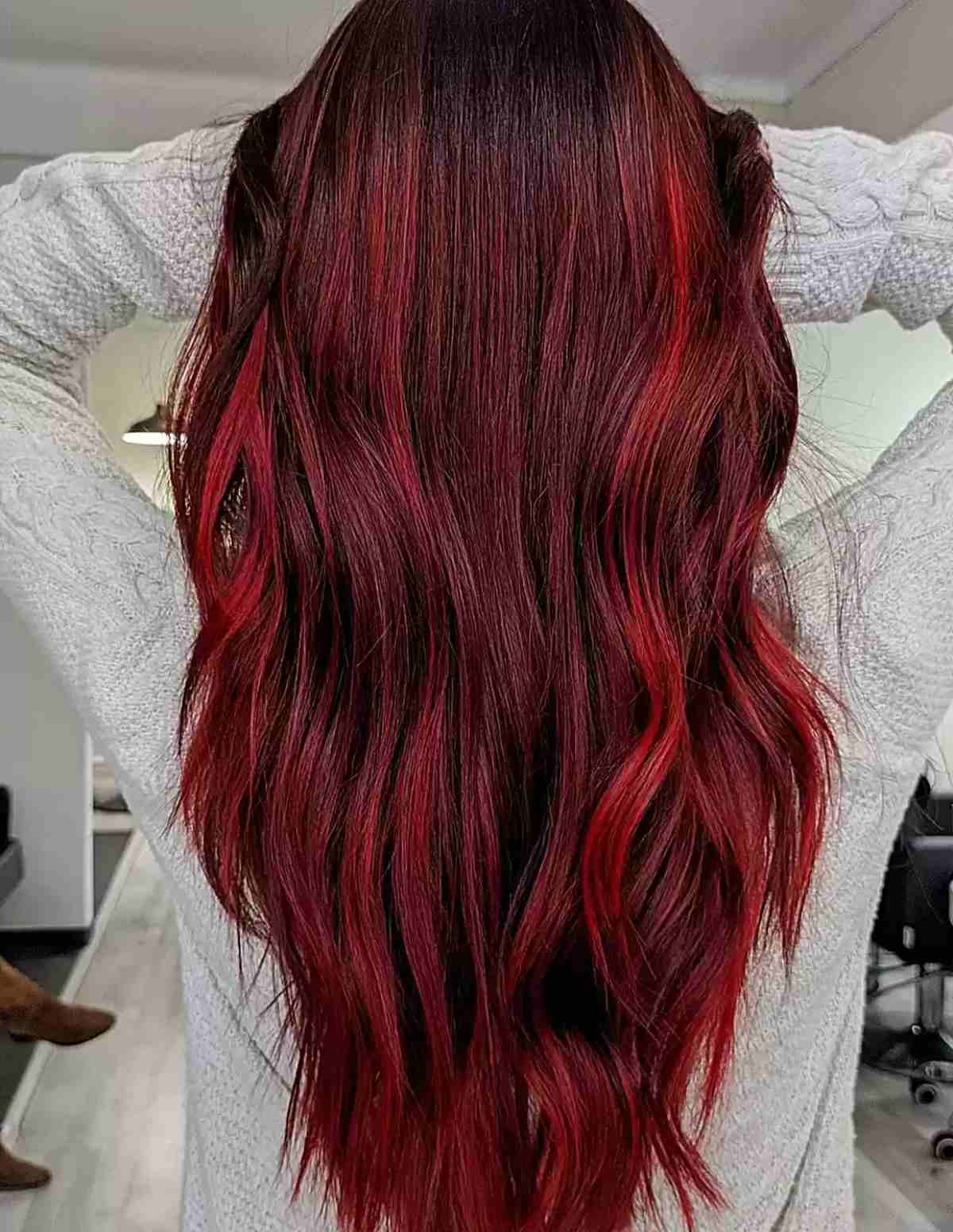 neon red balayage highlights with dark brown roots