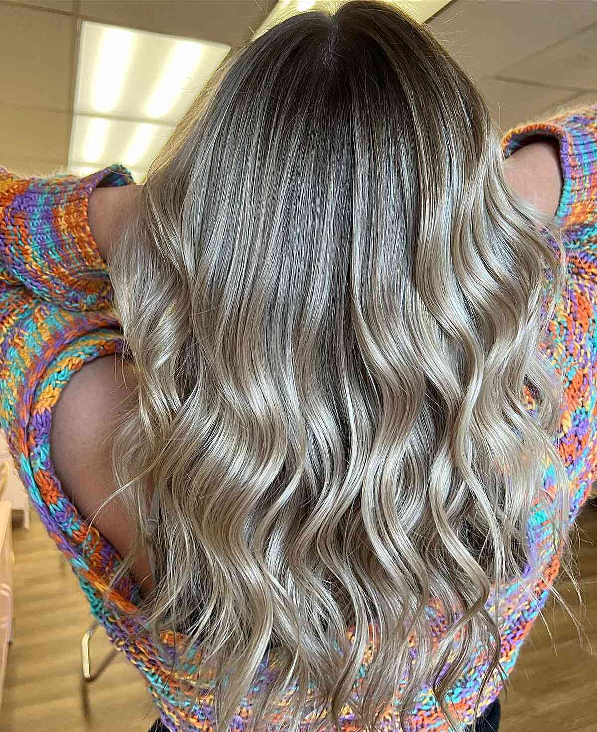 sandy dirty blonde balayage with dark roots