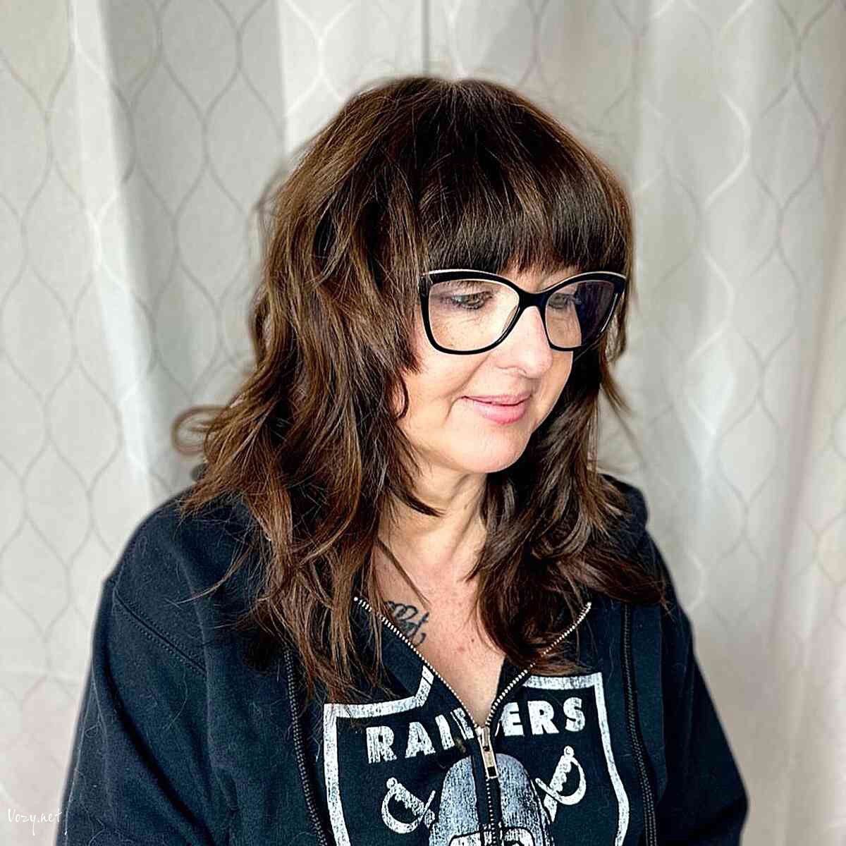 shaggy feathered layers with blunt bangs for older women over 60