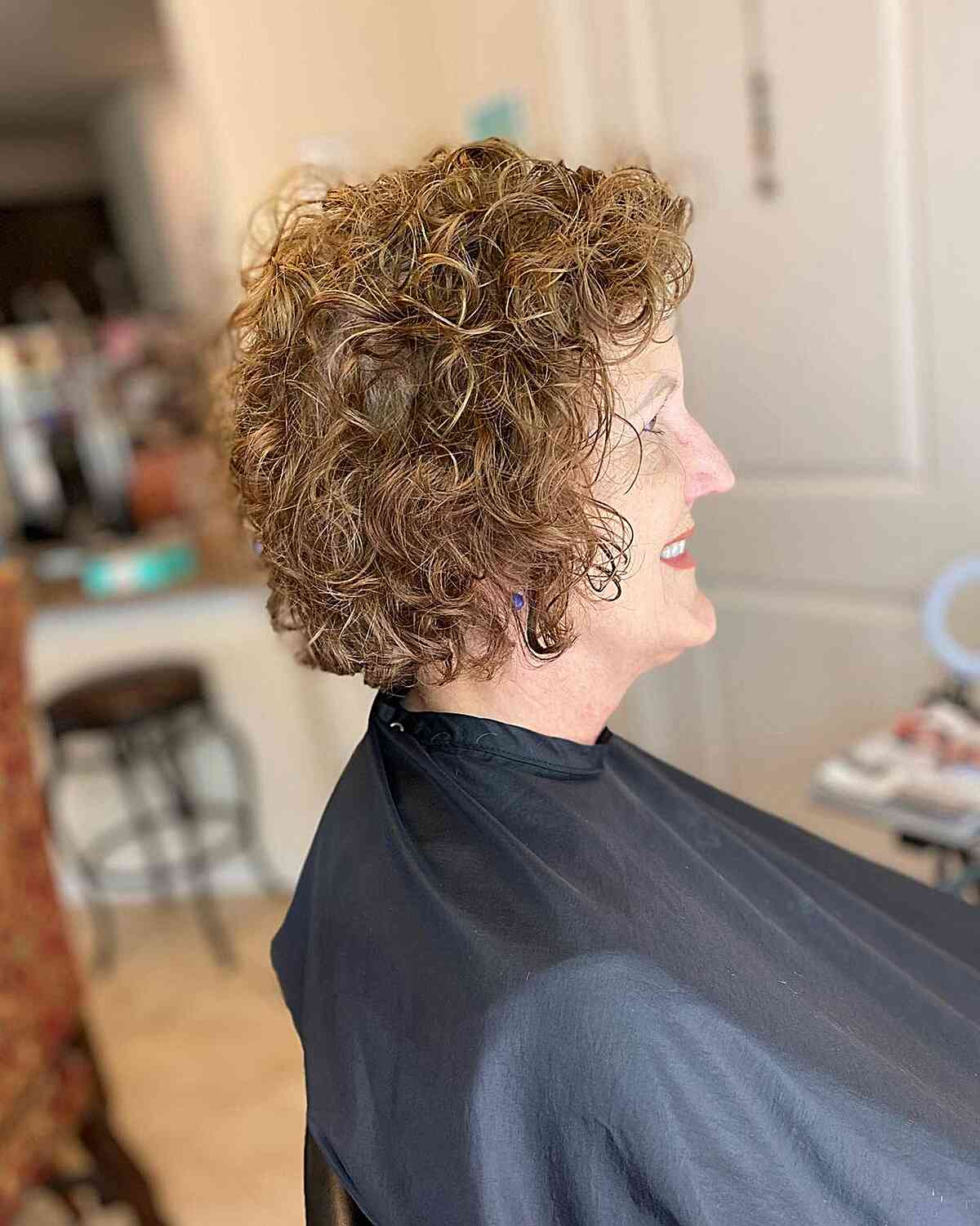 short jaw length crop with textured curls for women over 60