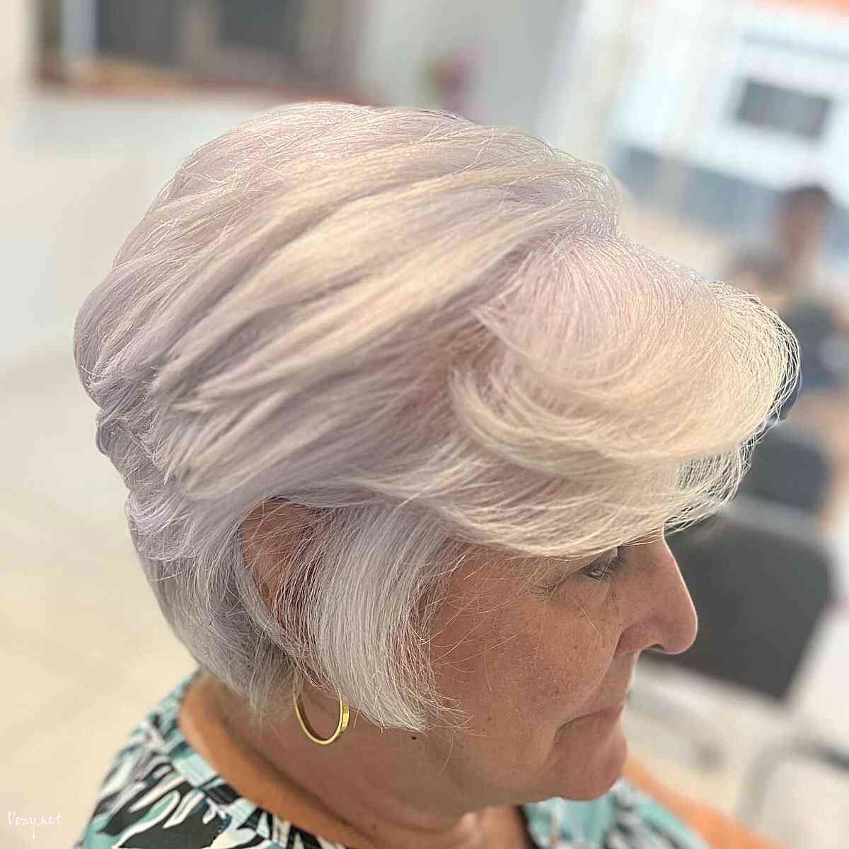 short layered white feathered lixie with swoopy bangs for 60 year old ladies