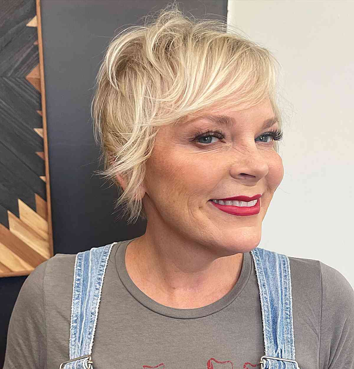 short length blonde shaggy bixie with side bagns for mature women