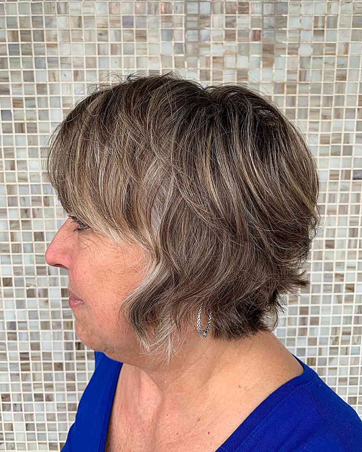 short shaggy bixie with soft bangs and choppy ends for an older woman