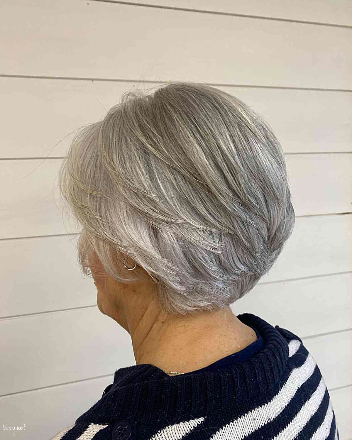 short stacked feathered bob with soft layers on women aged 60