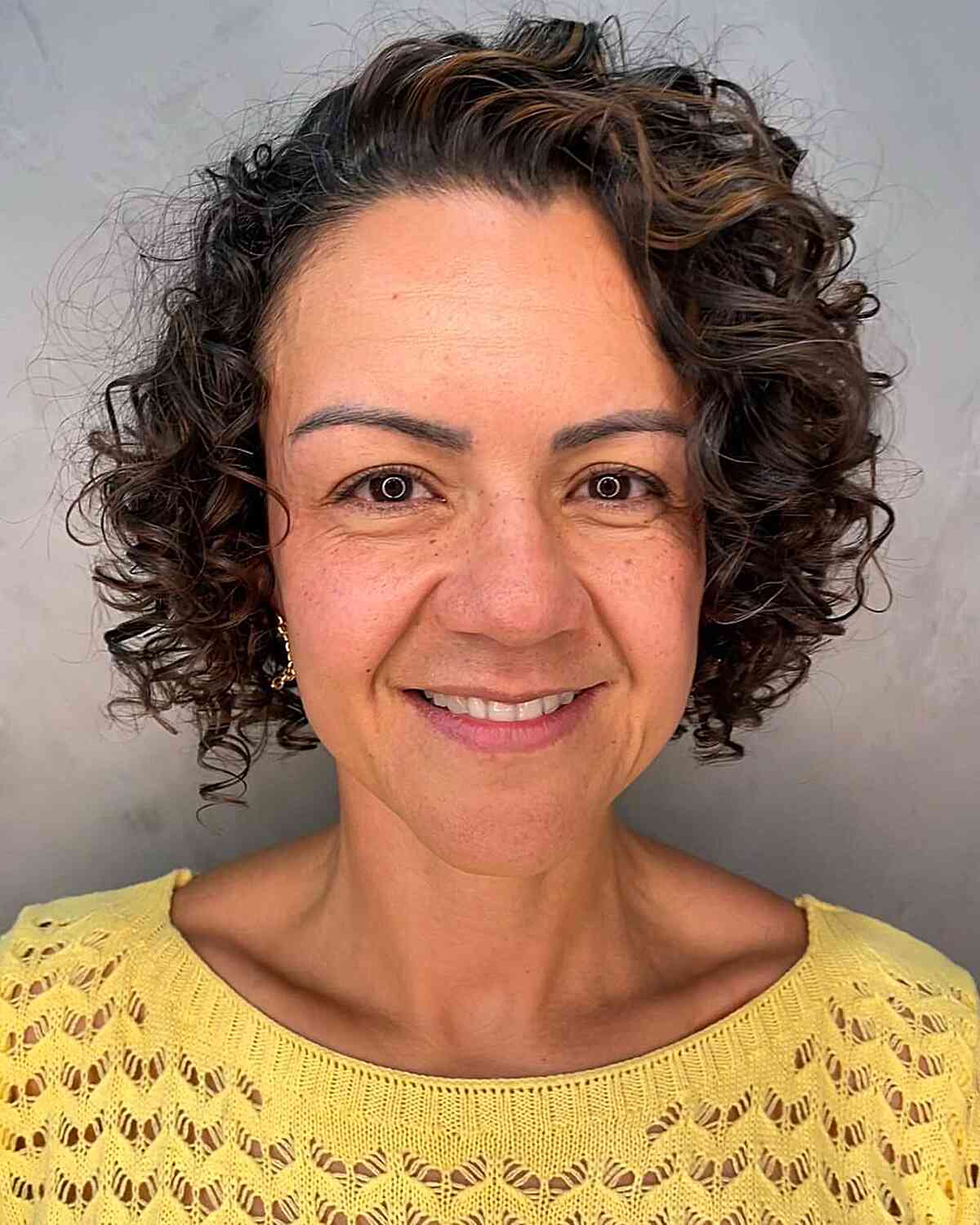 short voluminous curly bob for older women