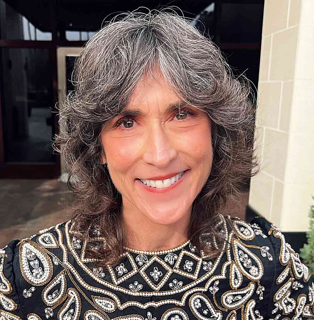 shorter length shag cut with flipped layers and curtain bangs for old women